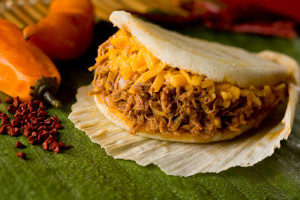 Arepas. Homemade with masa corn flour, Arepas are corn pockets stuffed with savory fillings—Venezuelan style meat, tuna, cheese, and eggplant.